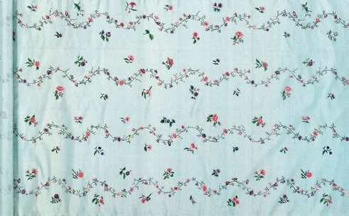 A bolt of fabric with a painted floral pattern